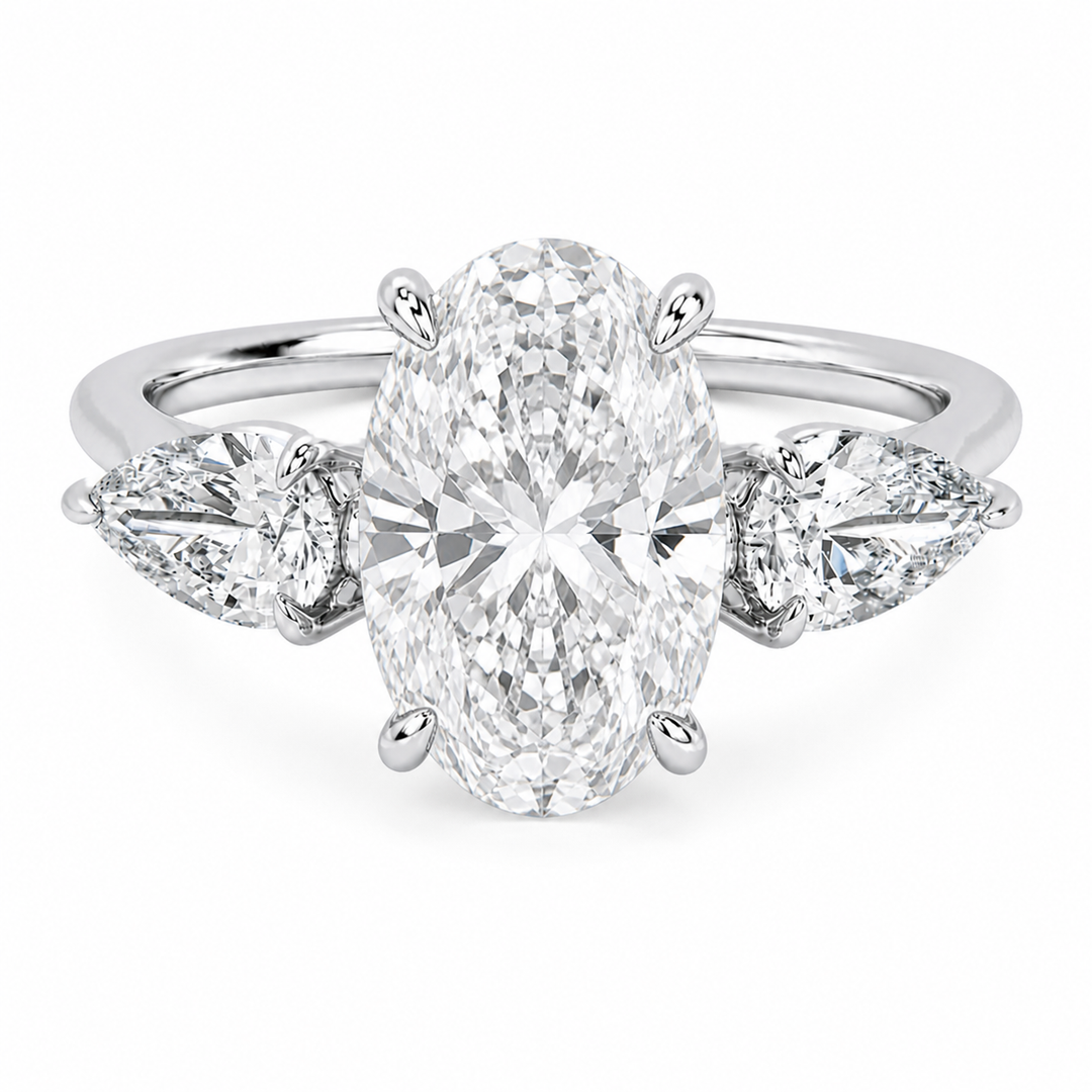 Ivy Signature 14K white gold engagement ring with a large oval center diamond and pear side stones.