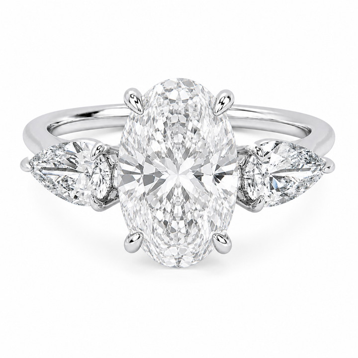 Ivy Signature 14K white gold engagement ring with a large oval center diamond and pear side stones.