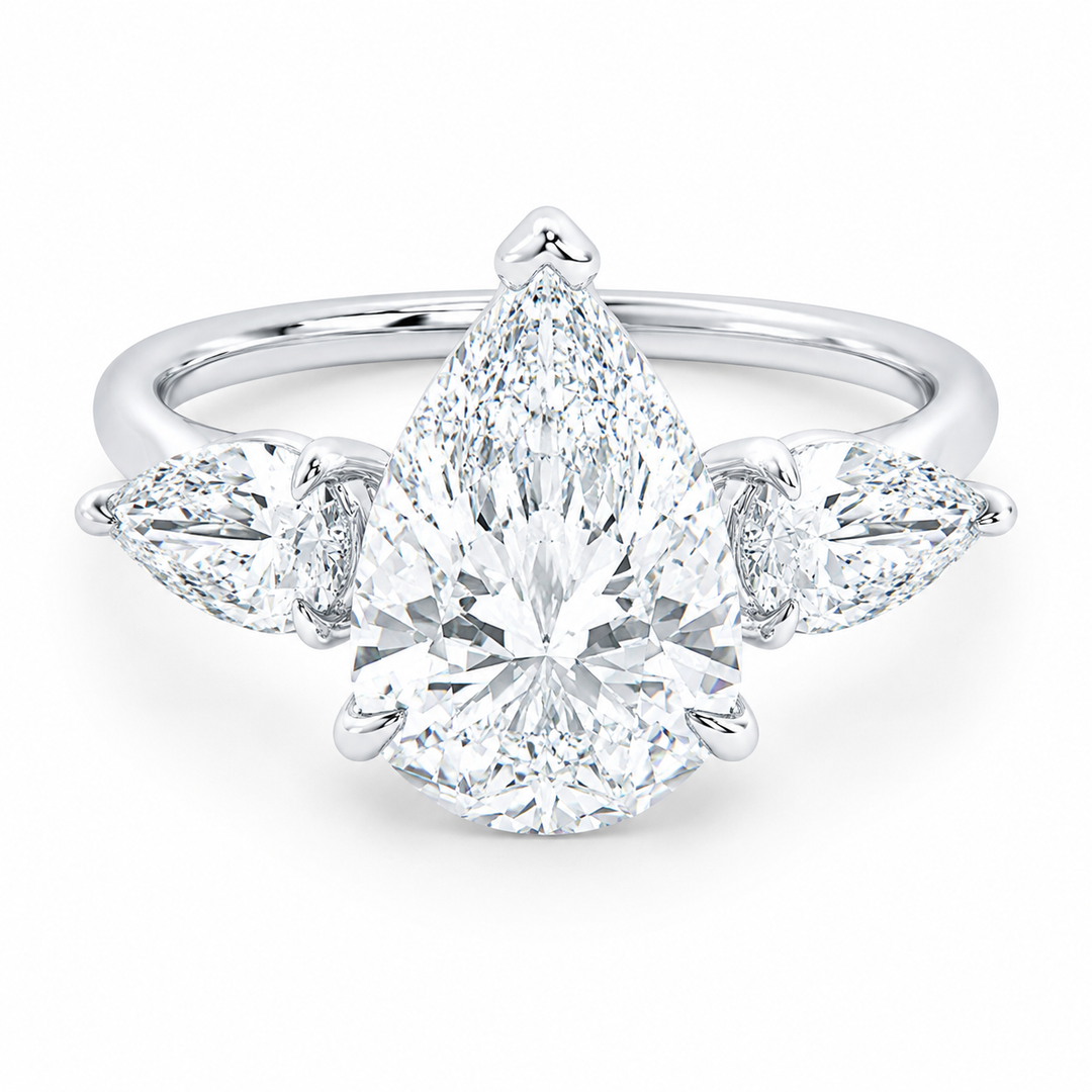 Ivy Signature engagement ring: 14K white gold band with a large pear-cut center diamond flanked by two smaller pear side stones.