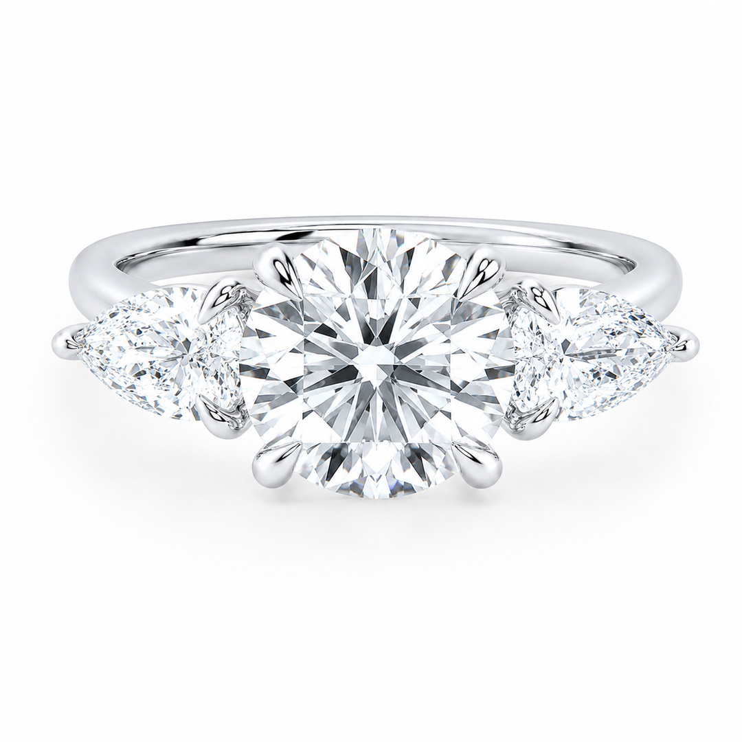 14K white gold Ivy Signature engagement ring with a round center diamond and pear side stones.
