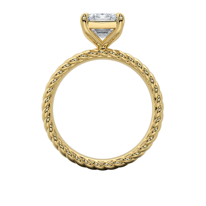 Gold engagement ring with an emerald-cut diamond and intricate rope band design.