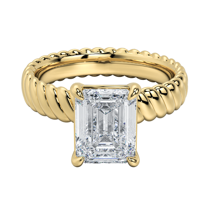 Jenn engagement ring: gold rope band with a prominent emerald-cut diamond.