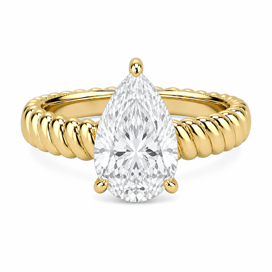 Jenn Signature engagement ring with a pear-shaped diamond center and a 14K yellow gold rope band.