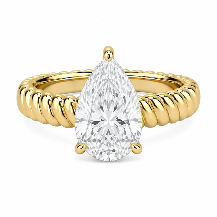 Jenn Signature engagement ring with a pear-shaped diamond center and a 14K yellow gold rope band.