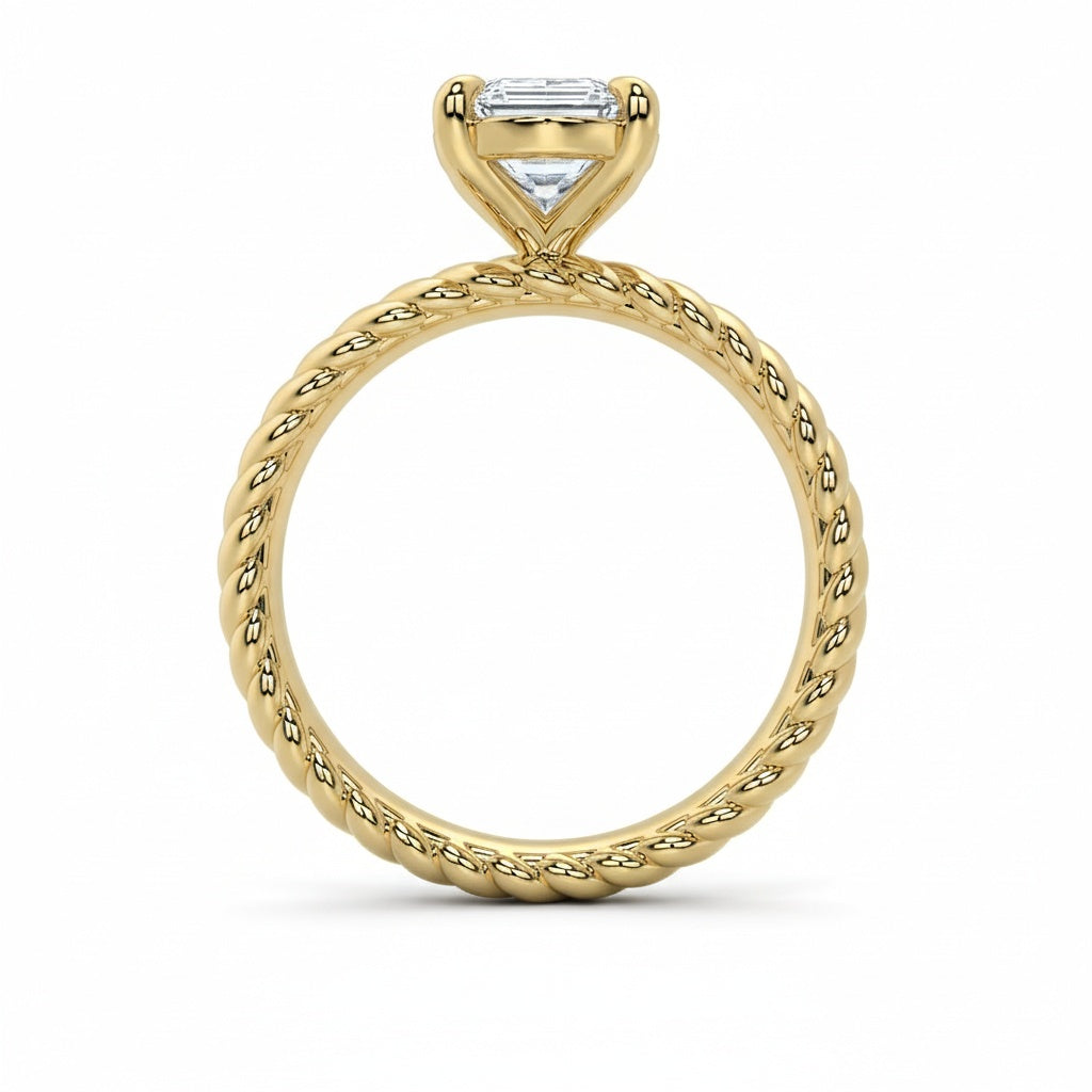 Jenn Signature engagement ring: 14K yellow gold rope band with a solitaire emerald-cut diamond.
