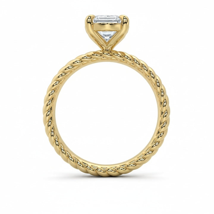 Jenn Signature engagement ring: 14K yellow gold rope band with a solitaire emerald-cut diamond.