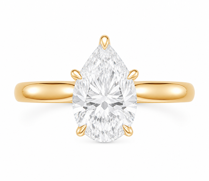 14K yellow gold modern solitaire engagement ring with a pear-shaped diamond and claw prongs.