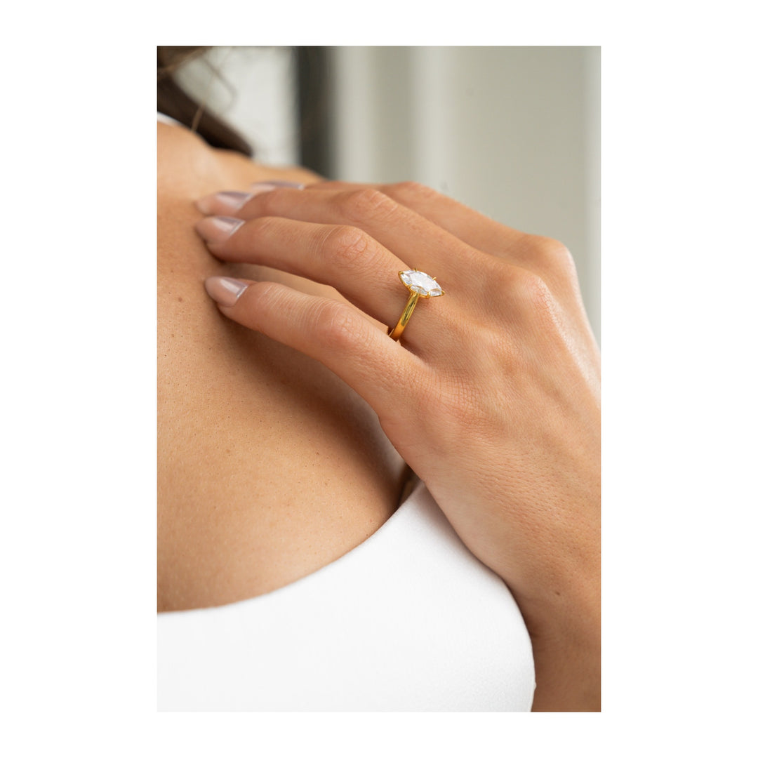 Leighton 14K gold engagement ring with a marquise diamond solitaire and cathedral shank.