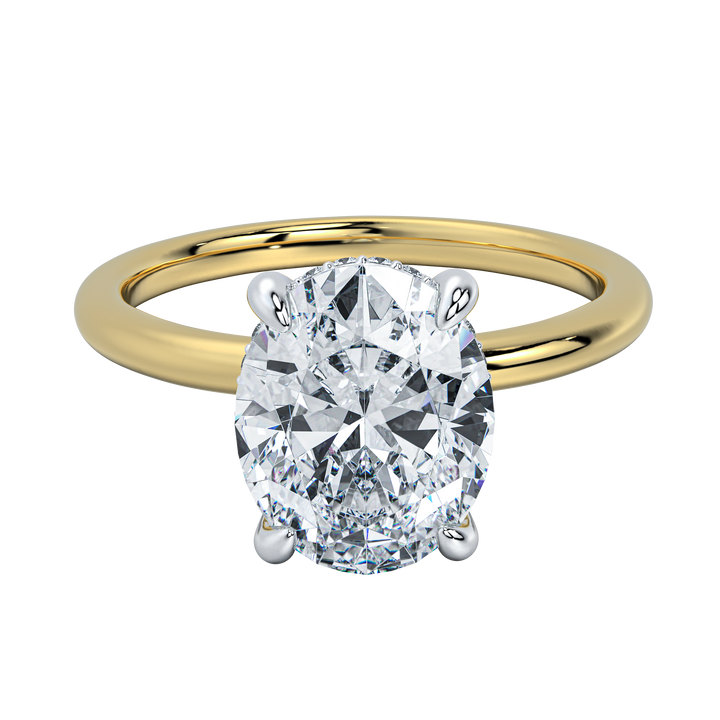 Margot solitaire engagement ring with an oval diamond, hidden halo, and yellow gold band.