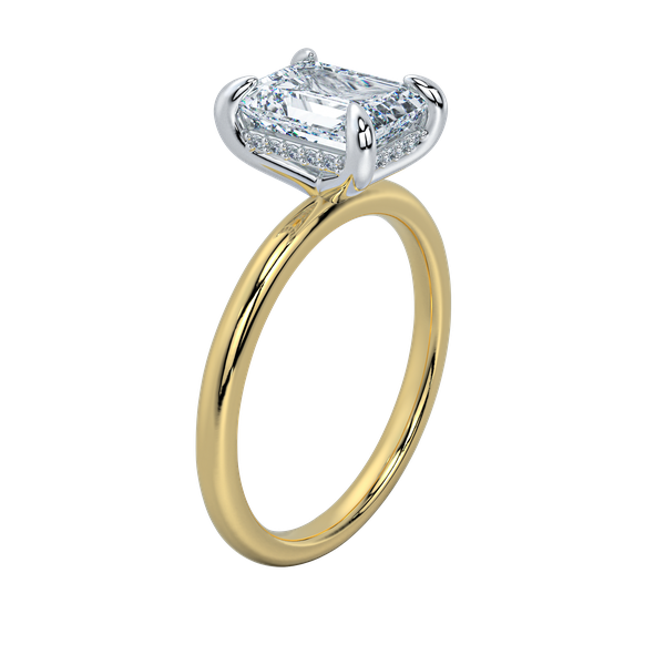 Margot solitaire engagement ring with a yellow gold band, white gold prongs, emerald cut diamond, and hidden halo.