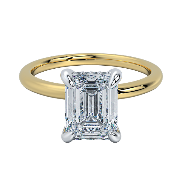 Margot solitaire engagement ring with an emerald cut diamond, yellow gold band, and platinum prongs.