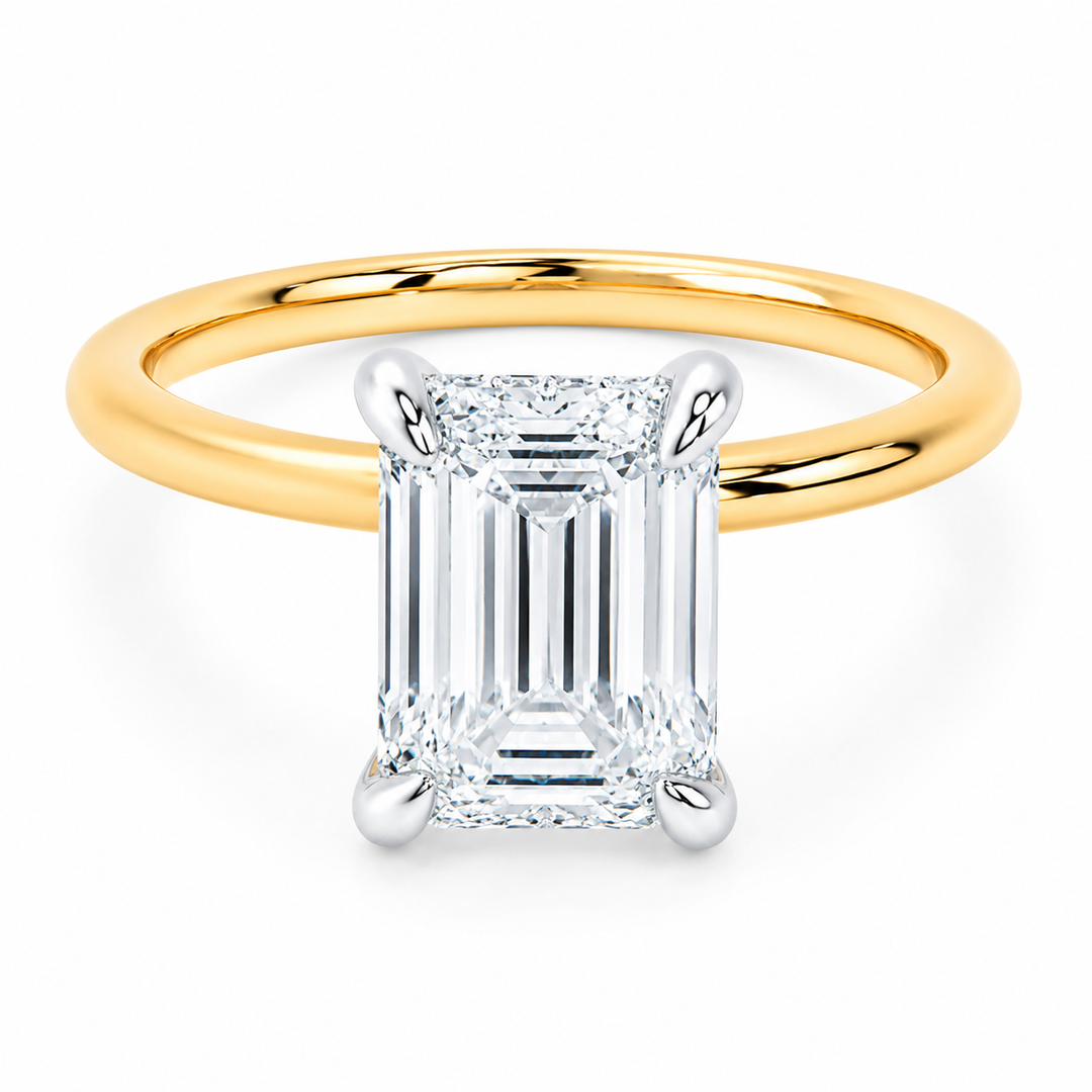 Margot engagement ring with 14K yellow gold band, white gold prongs, and an emerald cut diamond.