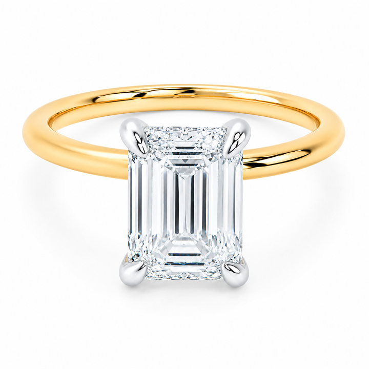 Margot engagement ring with 14K yellow gold band, white gold prongs, and an emerald cut diamond.