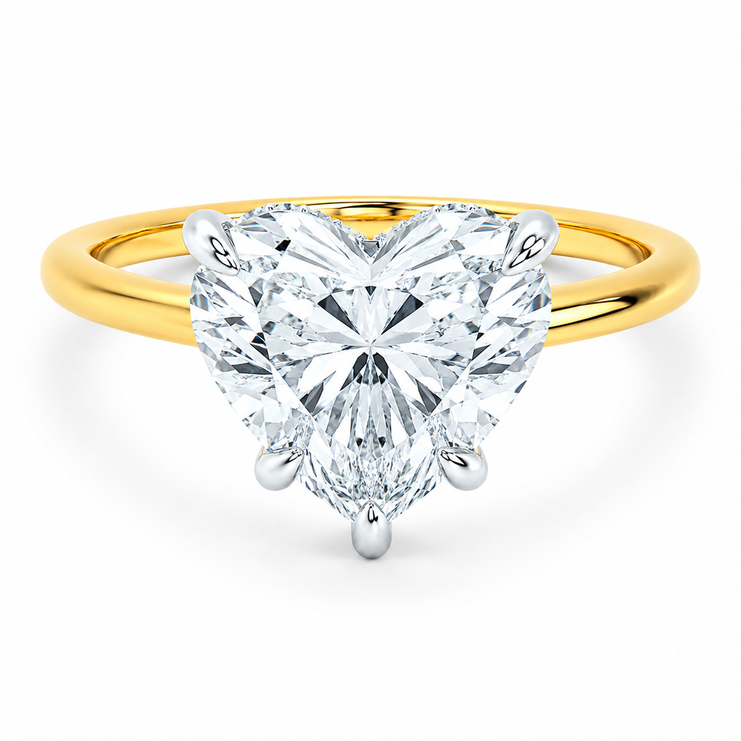 Margot engagement ring with a heart-shaped diamond, 14K yellow gold band, and white gold prongs.
