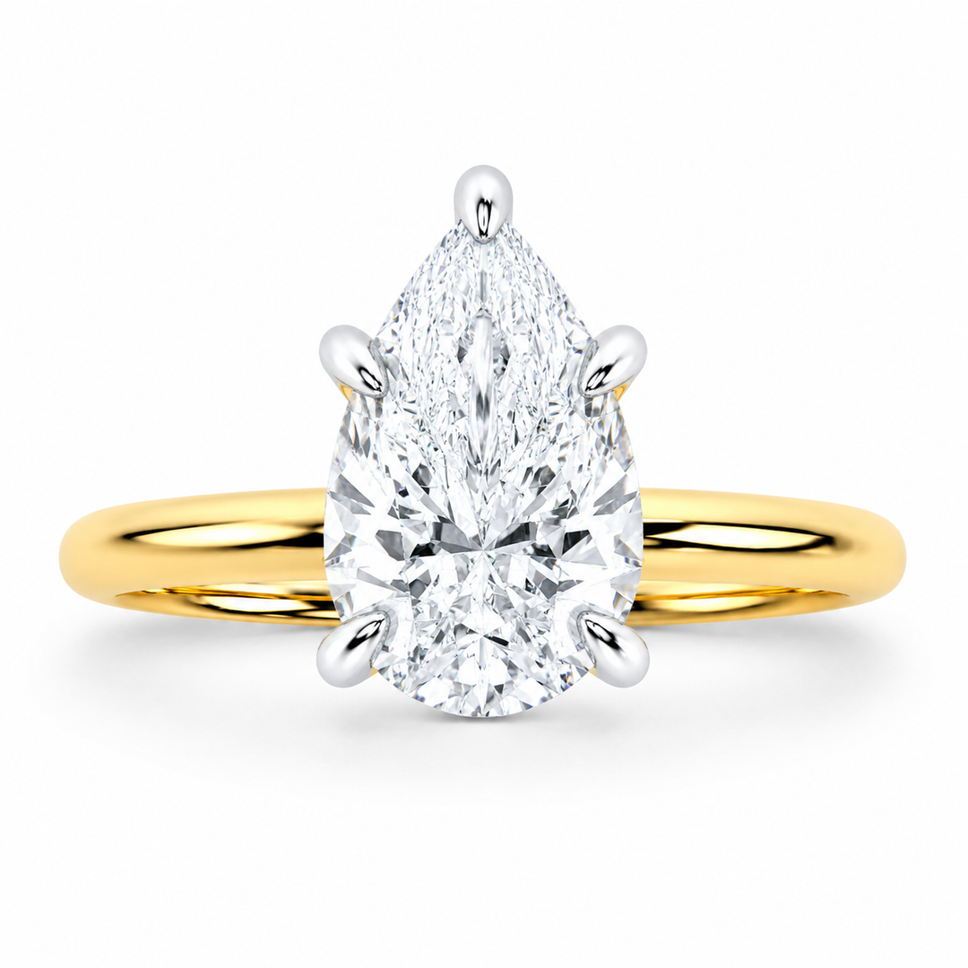 Margot Signature engagement ring with a pear-shaped diamond, 14K yellow gold band, and white gold prongs.