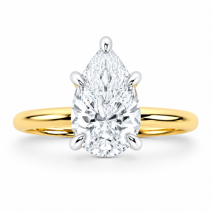 Margot Signature engagement ring with a pear-shaped diamond, 14K yellow gold band, and white gold prongs.