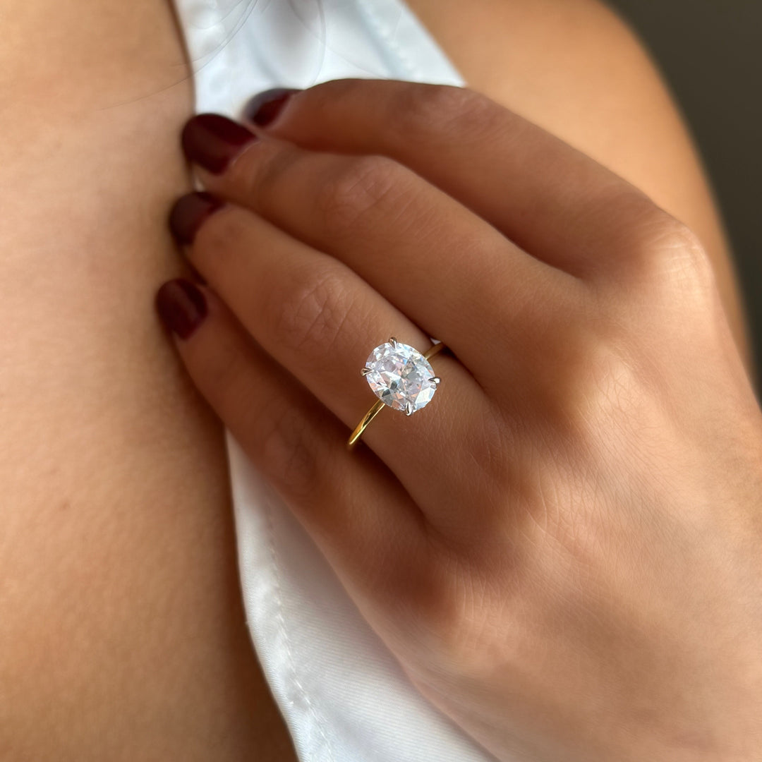 Margot Signature engagement ring: 14K yellow gold band with a large oval diamond and hidden halo.