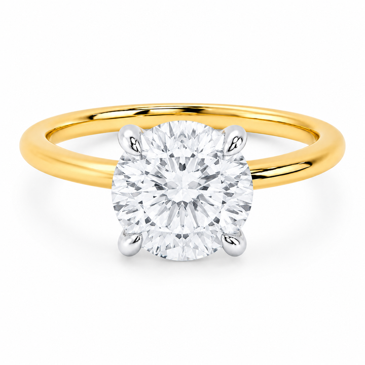 Margot Signature Engagement Style: 14K yellow gold band with a 2 CT round diamond in white gold prongs.