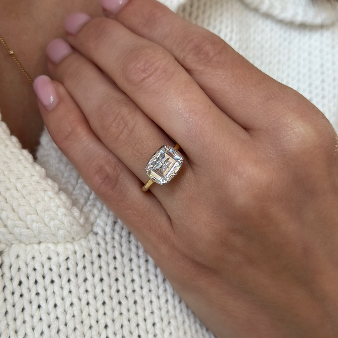Taylor two-tone 14K yellow and white gold engagement ring with a 2 CT emerald cut diamond.
