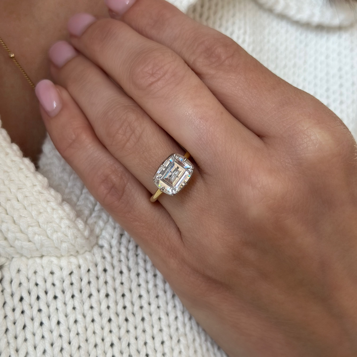 Taylor two-tone 14K yellow and white gold engagement ring with a 2 CT emerald cut diamond.