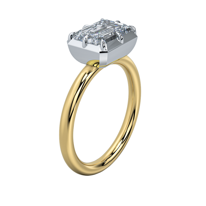 Taylor two-tone engagement ring with a 2 CT emerald cut diamond, 14K yellow gold band, and white gold claw prongs.