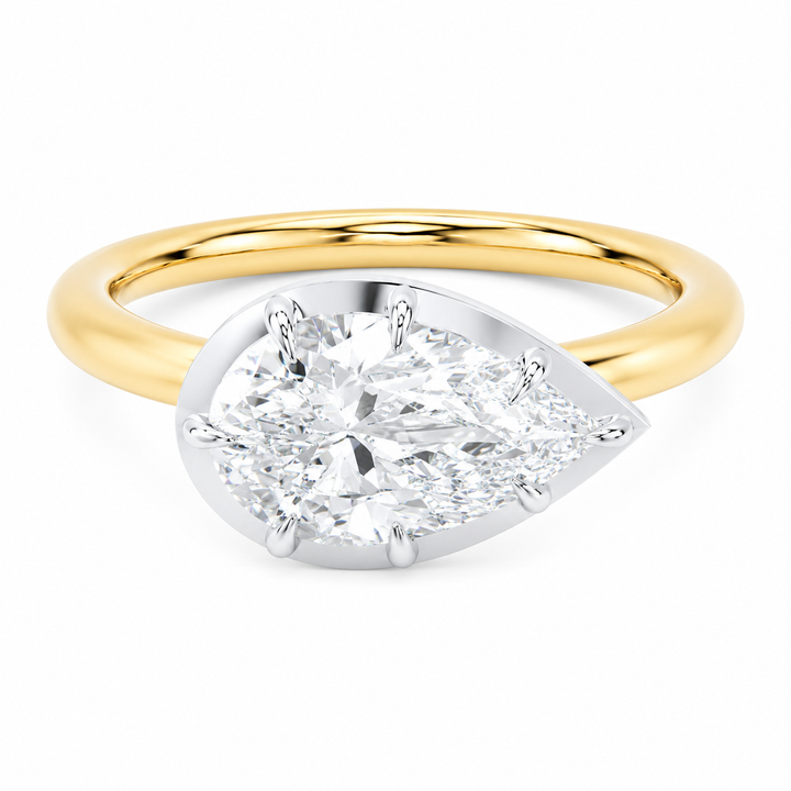 Taylor engagement ring with a pear-shaped diamond, two-tone 14K yellow and white gold, claw prongs.