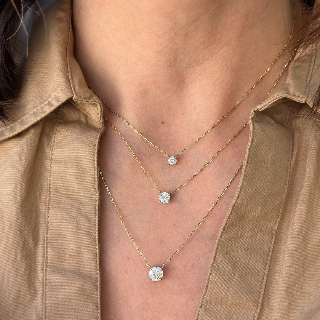 lab grown diamond solitaire necklace with a two-tone design, featuring a white gold basket setting and yellow gold chain.